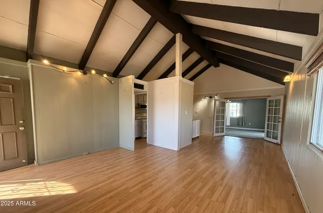 a view of a hallway with wooden floor