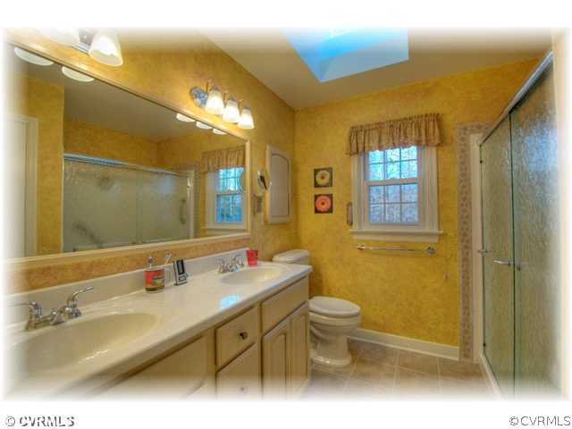 5106 Rock Harbour Road Midlothian, VA 23112 - Photo 8 of 12 a bathroom with a double vanity sink toilet and a mirror