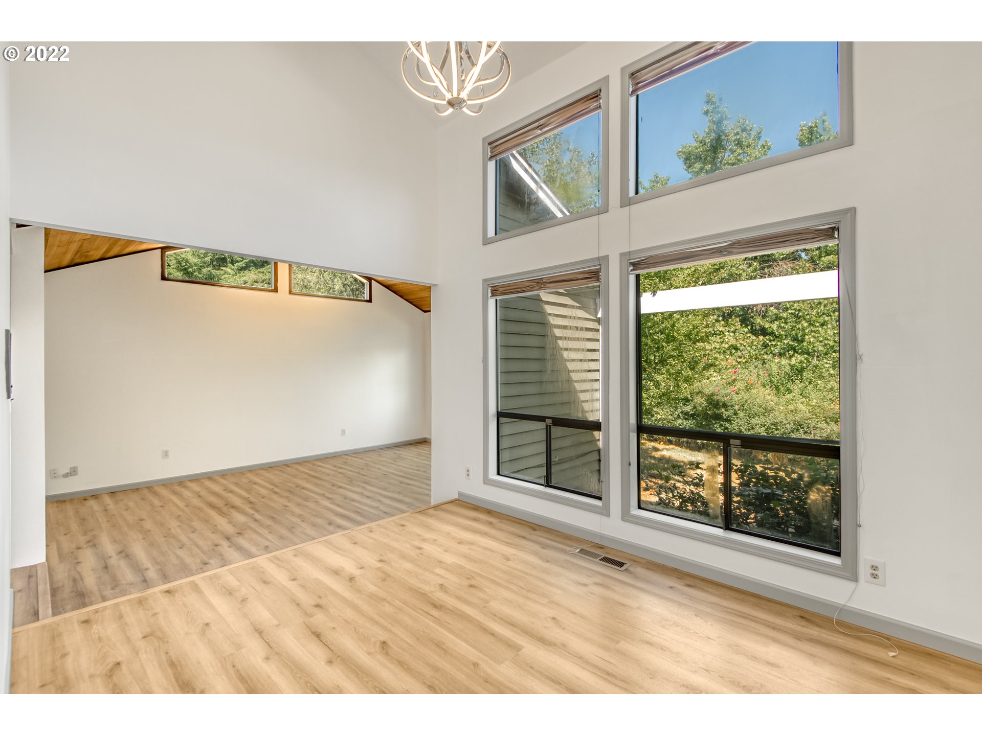 4435 Southeast Regner Road Gresham, OR 97080 - Photo 11 of 32 a view of an empty room with wooden floor and a window