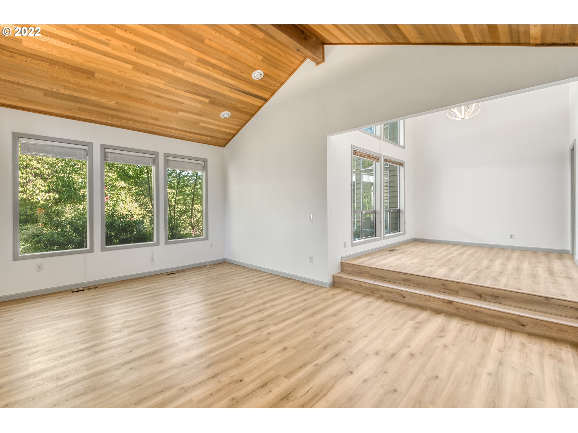 4435 Southeast Regner Road Gresham, OR 97080 - Photo 12 of 32 a view of an empty room with wooden floor and a window