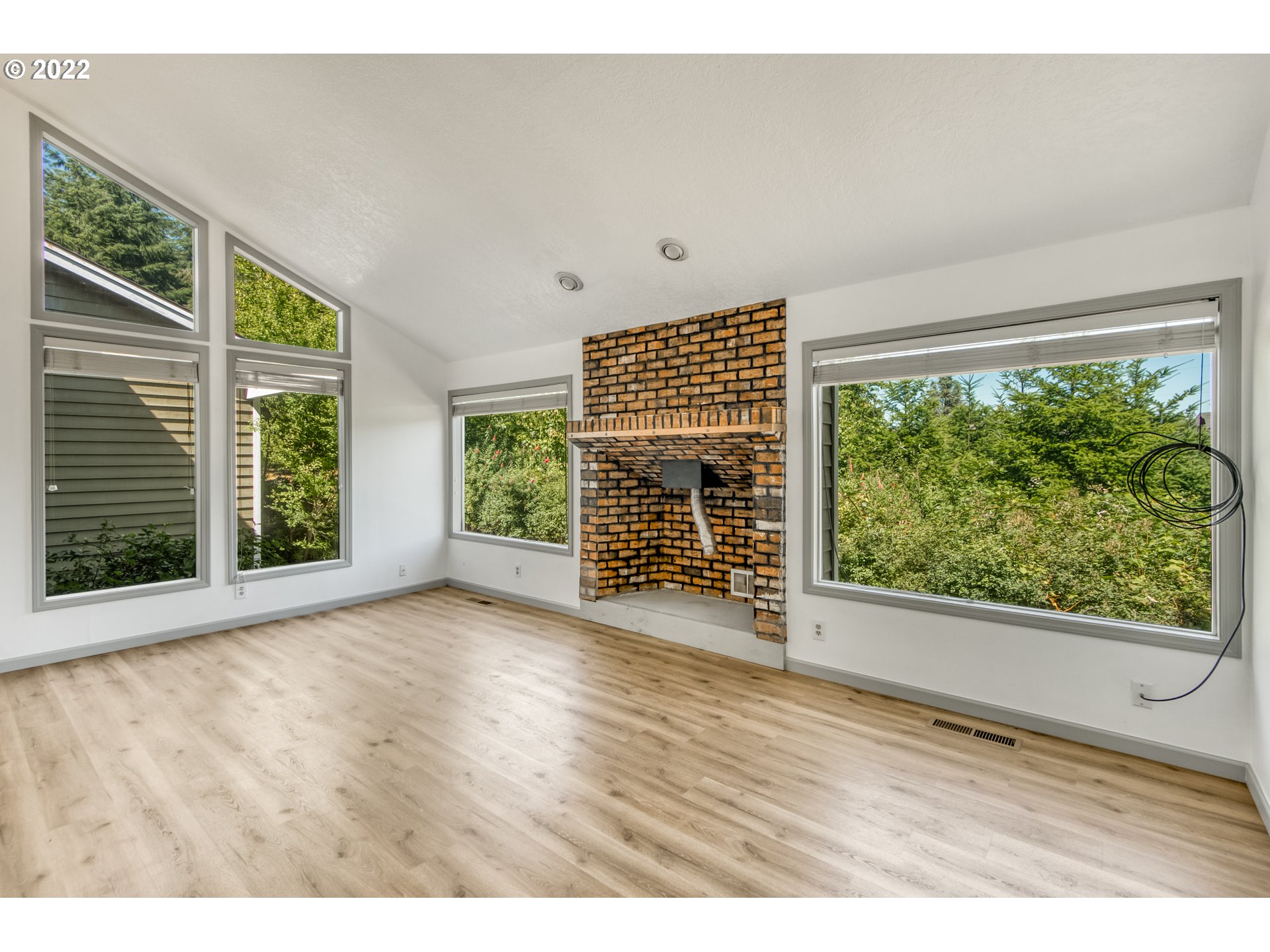 4435 Southeast Regner Road Gresham, OR 97080 - Photo 16 of 32 a view of an empty room with wooden floor and a window