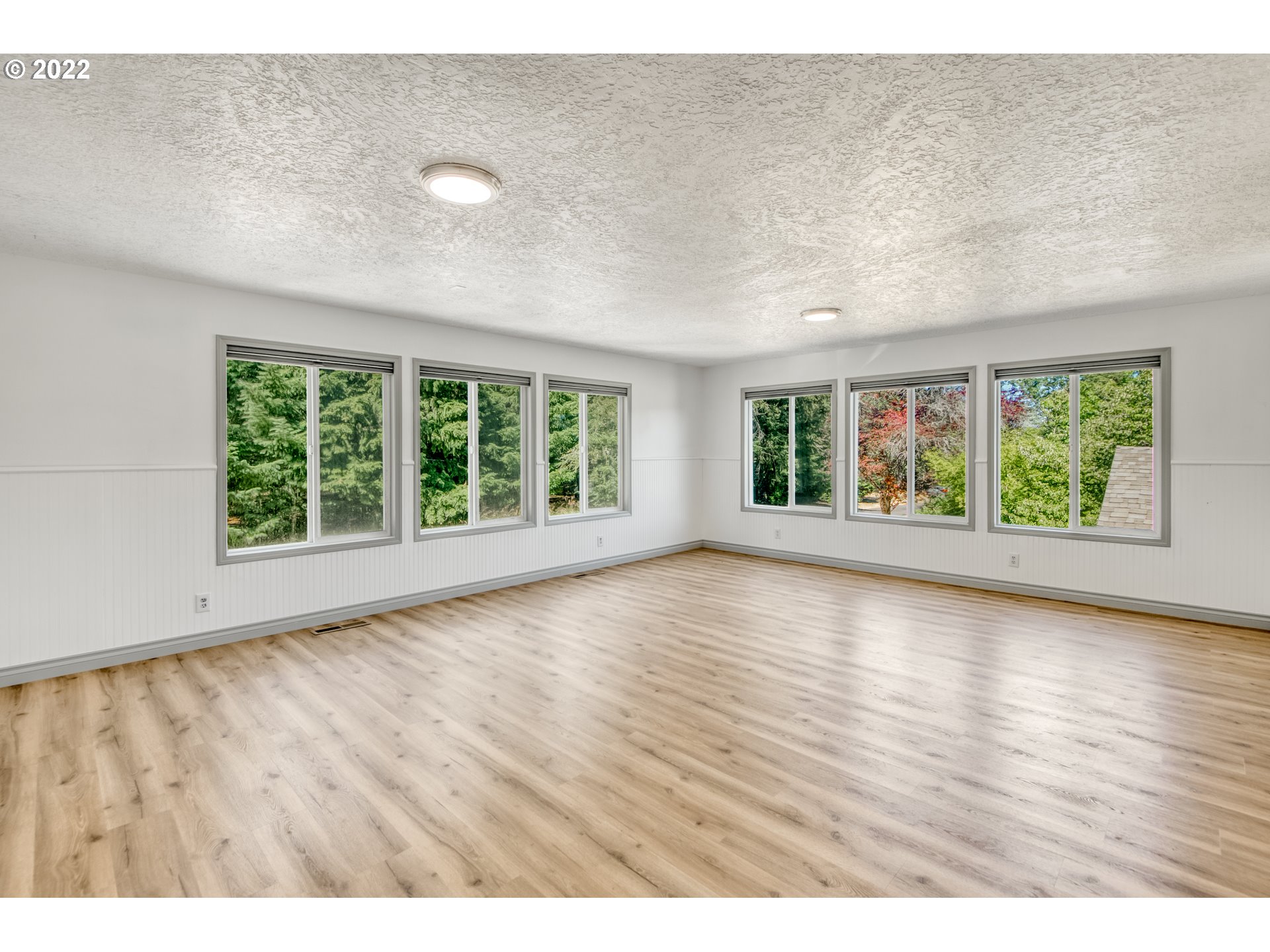 4435 Southeast Regner Road Gresham, OR 97080 - Photo 28 of 32 an empty room with wooden floor and windows