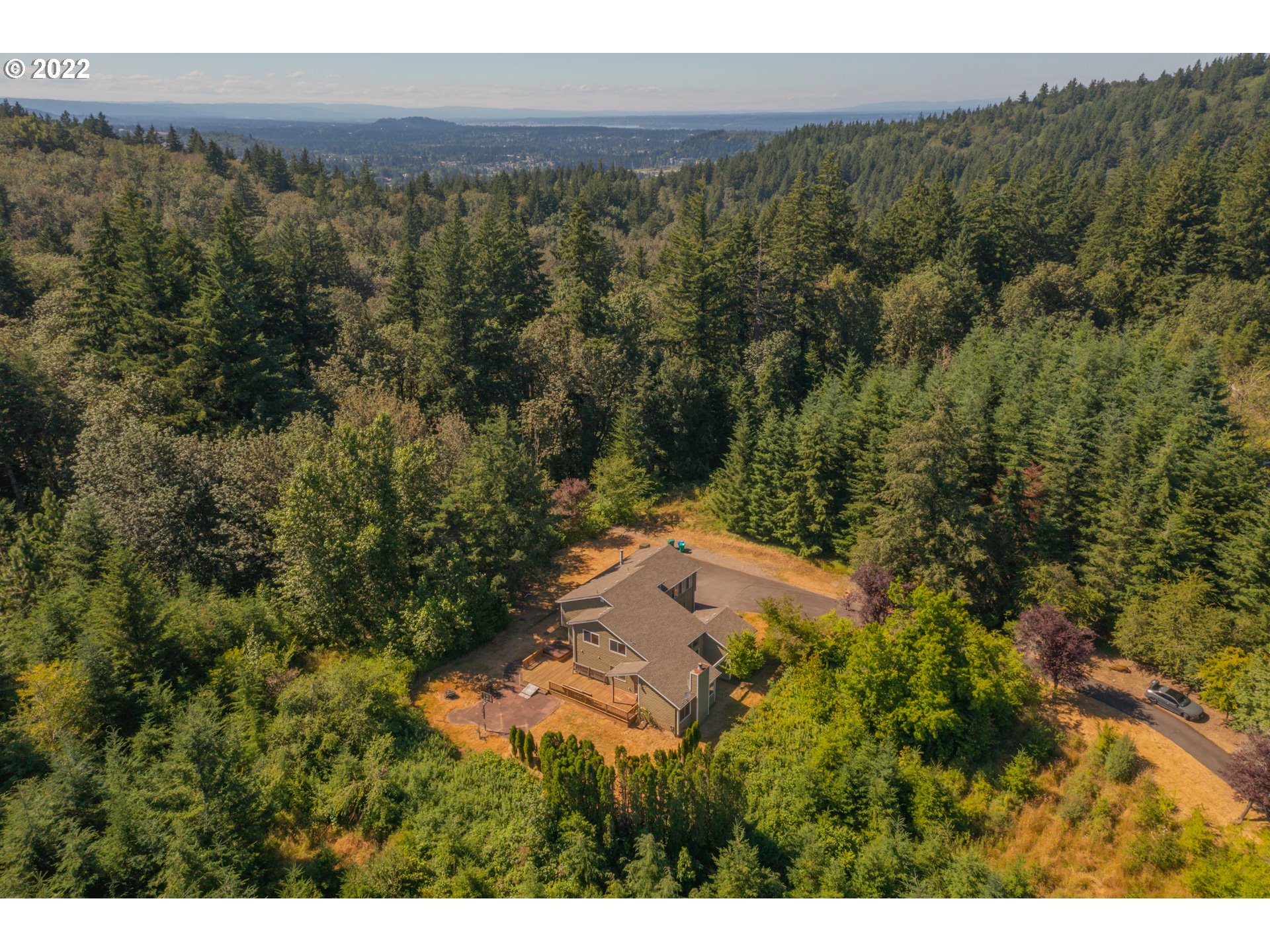 4435 Southeast Regner Road Gresham, OR 97080 - Photo 31 of 32 a view of a lush green forest with trees and some houses