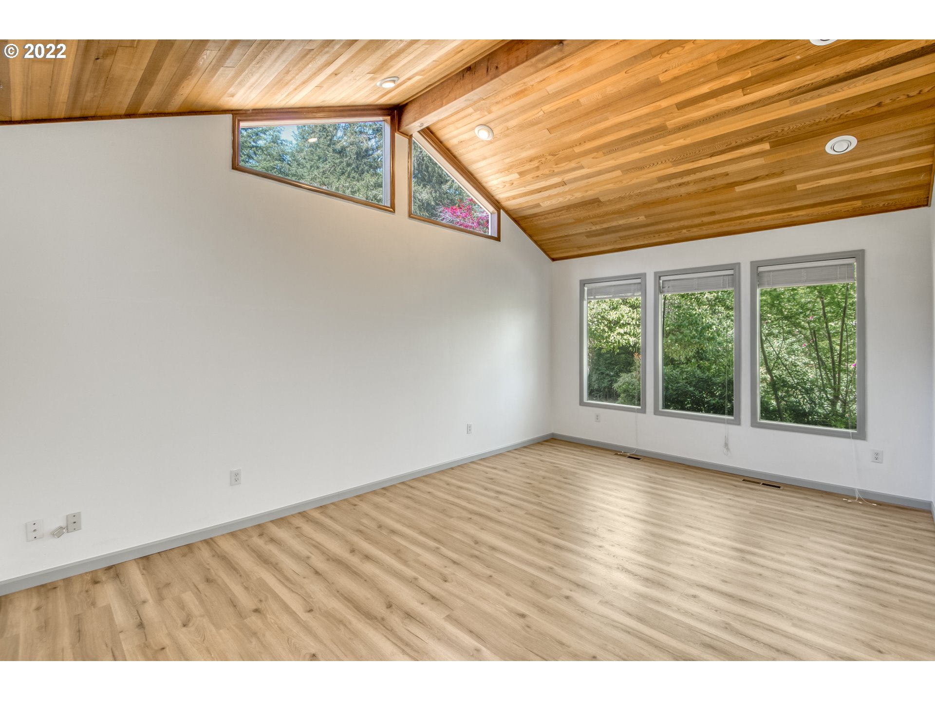 4435 Southeast Regner Road Gresham, OR 97080 - Photo 9 of 32 a view of an empty room with wooden floor and a window