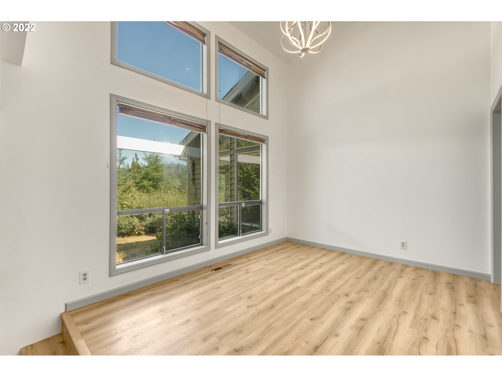 4435 Southeast Regner Road Gresham, OR 97080 - Photo 10 of 32 a view of an empty room with wooden floor and a window