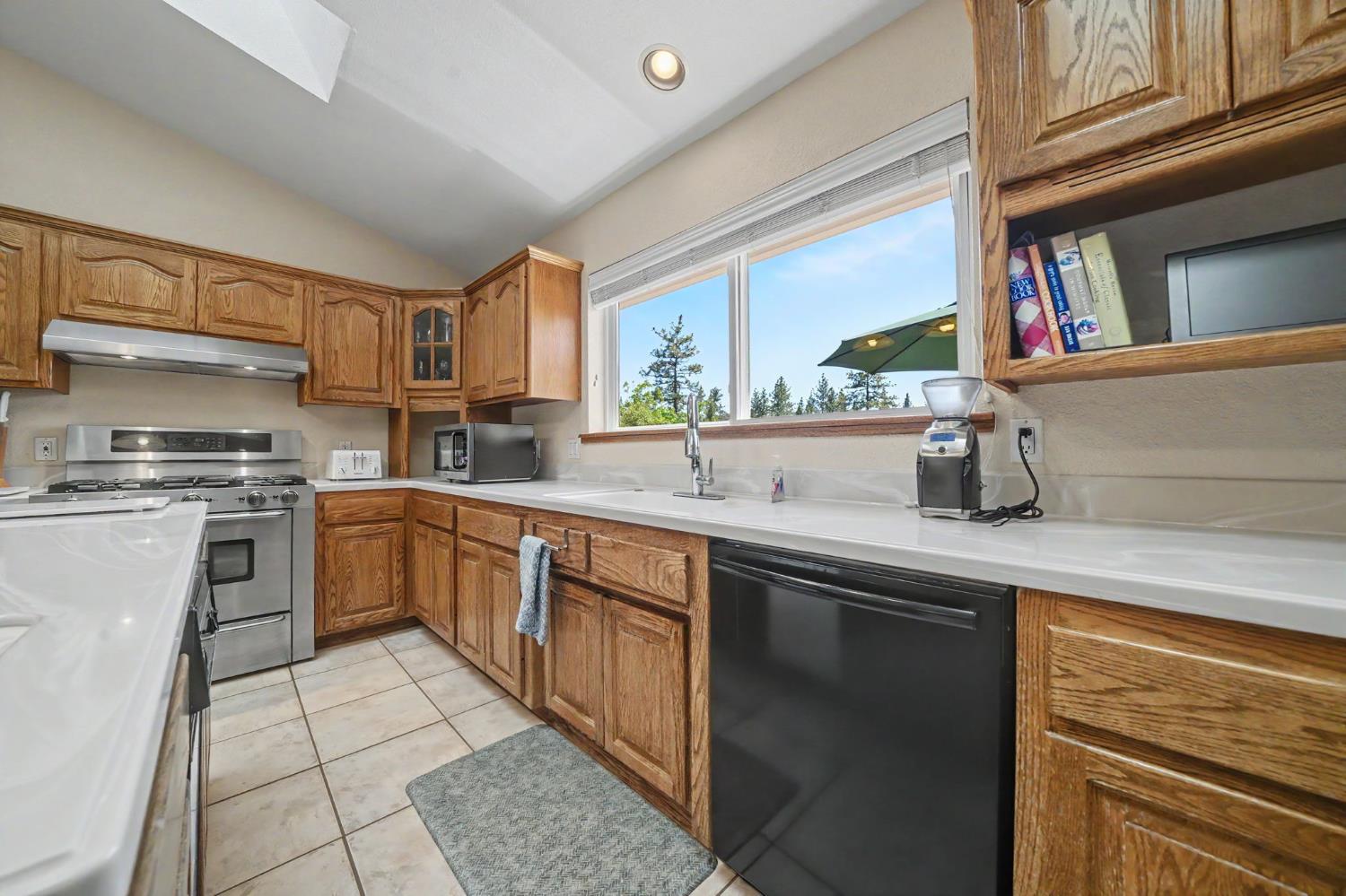 18299 West Clinton Road Jackson, CA 95642 - Photo 26 of 56 a kitchen with a sink stove and cabinets