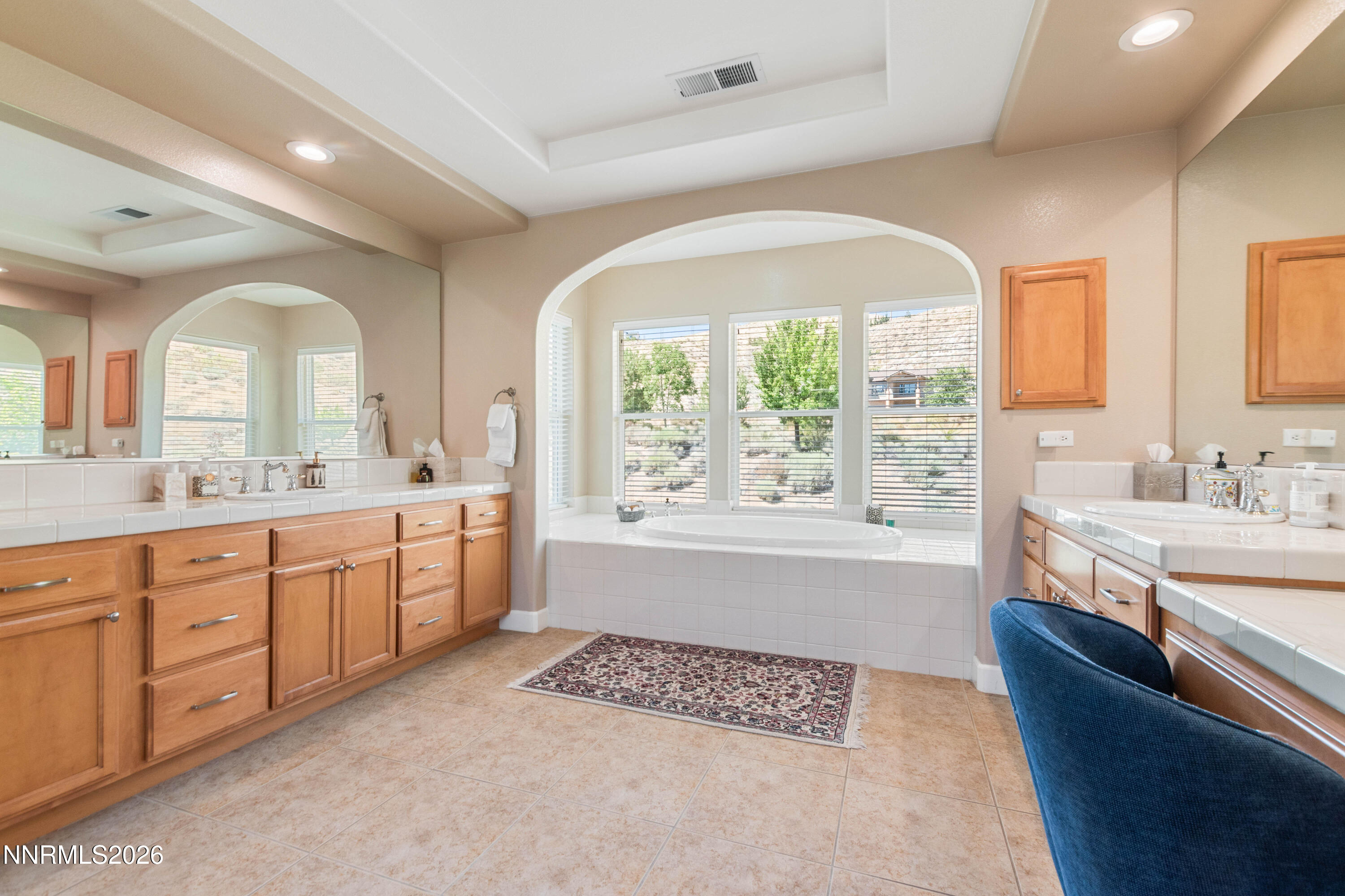 2395 Ridge Field Trail Reno, NV 89523 - Photo 26 of 44 a spacious bathroom with a double vanity sink a two mirror a bathtub and next to a window