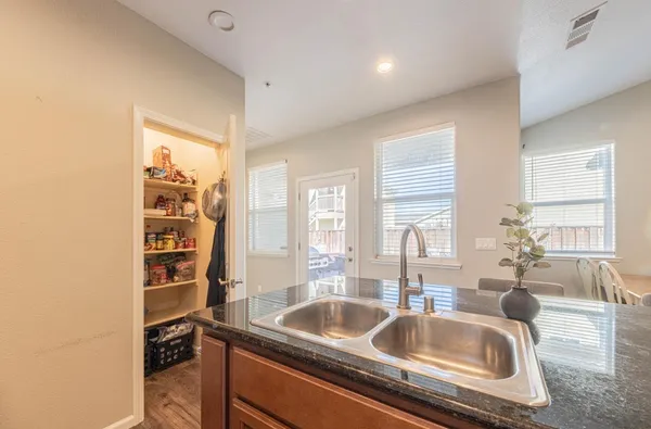 a kitchen with a sink and a large window