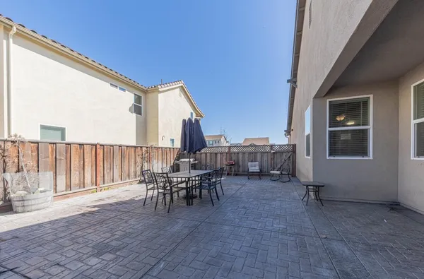 a view of balcony with chairs and iron fence