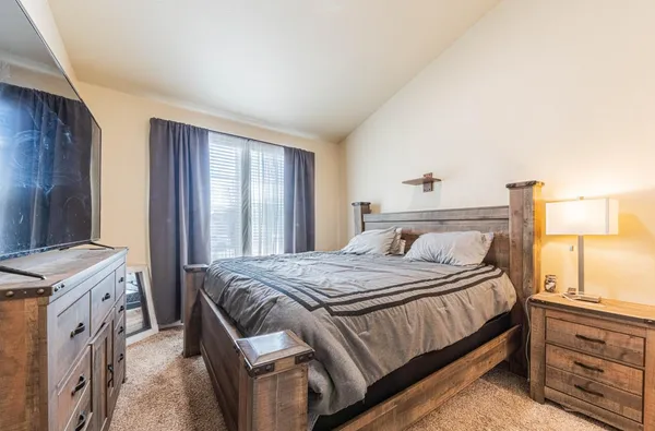 a bedroom with a bed and a window