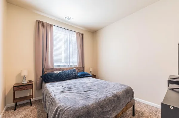 a bedroom with a bed and a chair