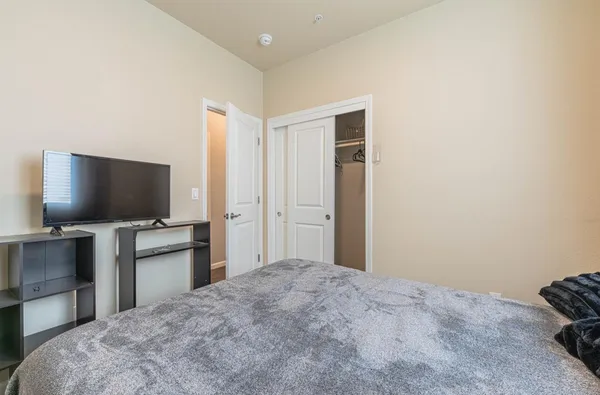 a bedroom with a bed and a flat screen tv