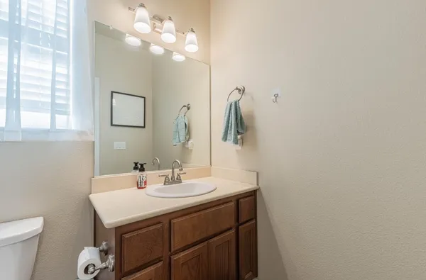 a bathroom with a sink vanity and a mirror