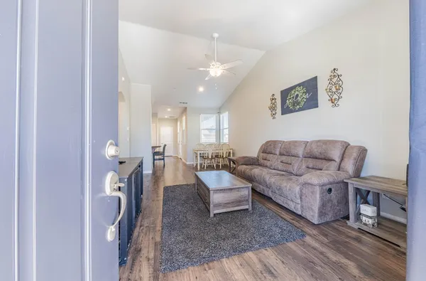 a living room with furniture and wooden floor