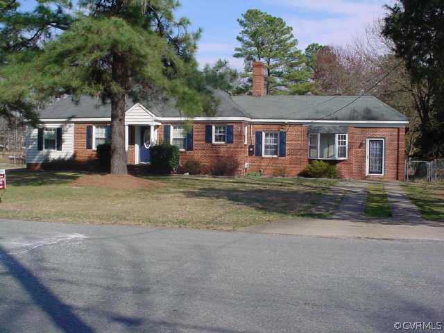 5207 Coxson Road Sandston, VA 23150 - Photo 1 of 5 a front view of a house with a garden