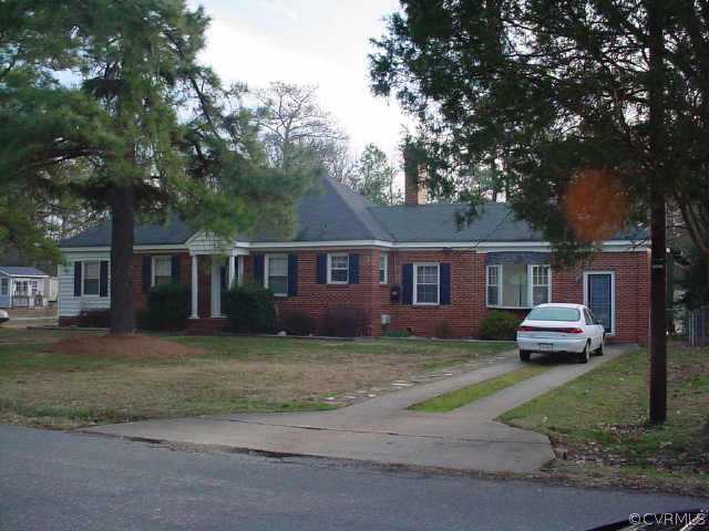 5207 Coxson Road Sandston, VA 23150 - Photo 5 of 5 a front view of a house with a garden and tree