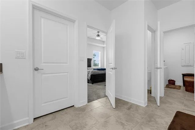 a view of a livingroom with wooden floor and a bathroom