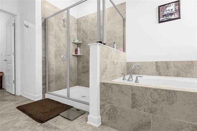 a bathroom with a tub and a shower