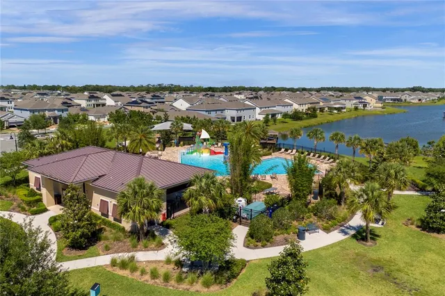 a view of swimming pool with outdoor seating and plants
