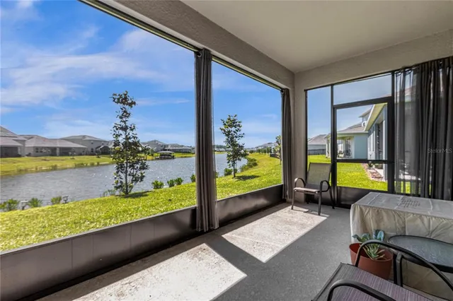 a living room with furniture and a floor to ceiling window
