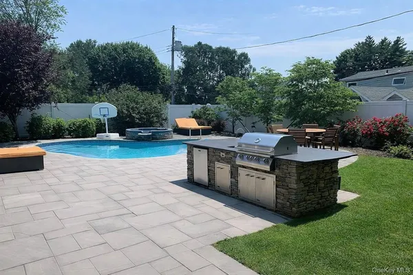 a view of a backyard with sitting area