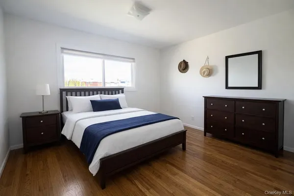 a bed sitting in a bedroom next to a window