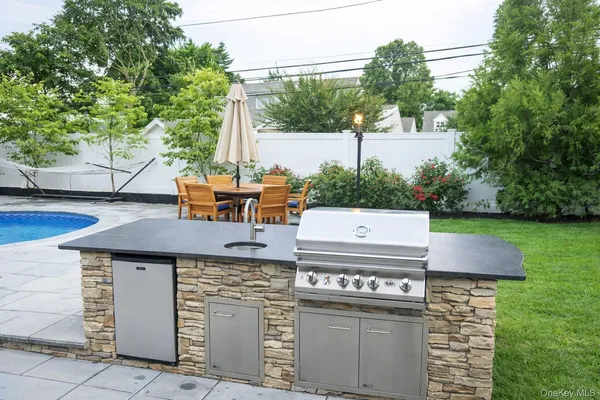 a view of a yard with table chairs and a fire pit