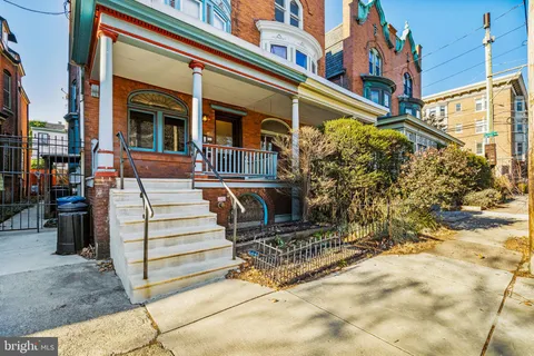 a view of a house with a large windows and stairs