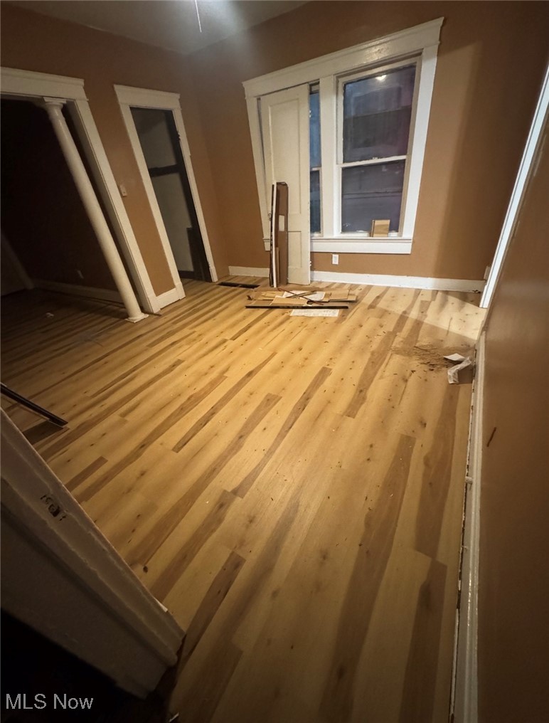 12406 Kinsman Road Cleveland, OH 44120 - Photo 9 of 29 Empty room with wood finished floors and baseboards