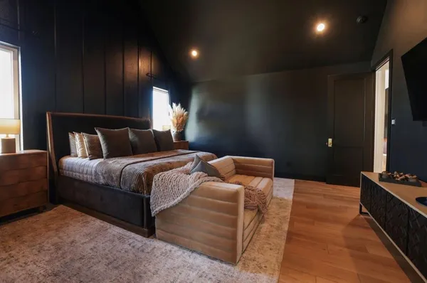 a spacious bedroom with a bed and a ceiling fan