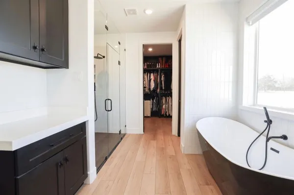 a bathroom with a sink vanity and shower