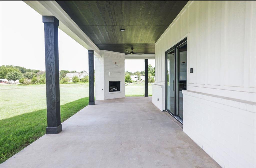 6724 Clearwater Ranch Road Wills Point, TX 75169 - Photo 36 of 38 a view of a porch with a floor to ceiling window and a yard