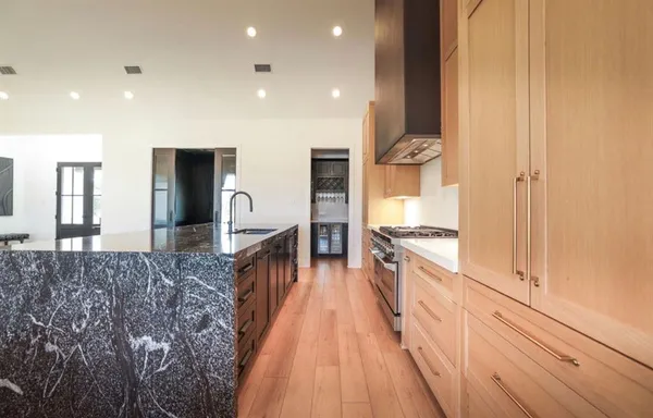 a spacious bathroom with a double vanity sink and a mirror