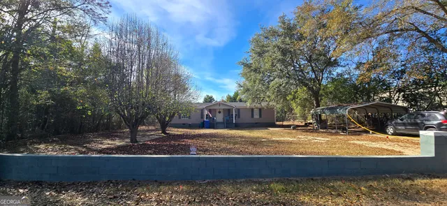 a view of a house with yard and sitting area