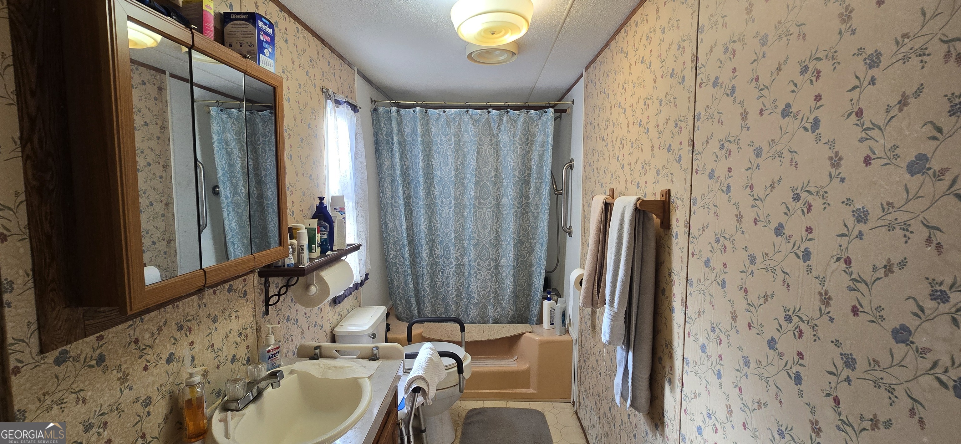 912 Druid Street Dublin, GA 31021 - Photo 19 of 32 a bathroom with a sink and a mirror