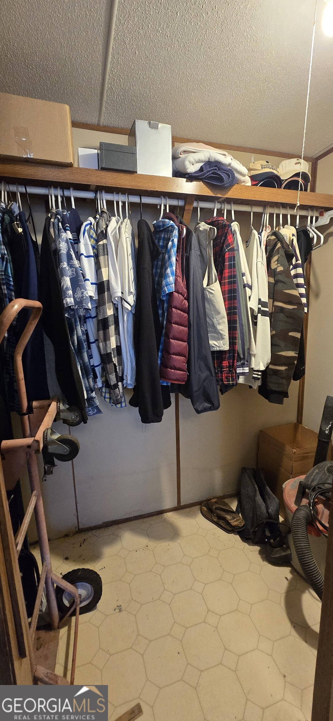 912 Druid Street Dublin, GA 31021 - Photo 24 of 32 a view of walk in closet with clothes and shoes
