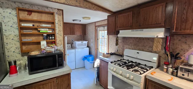 a kitchen with stainless steel appliances stove and cabinets