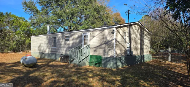 a backyard of a house with table and chairs
