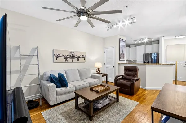 a living room with furniture a rug and a chandelier
