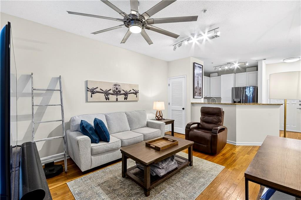 10 Perimeter Summit Boulevard, Unit 4113 Brookhaven, GA 30319 - Photo 15 of 53 a living room with furniture a rug and a chandelier