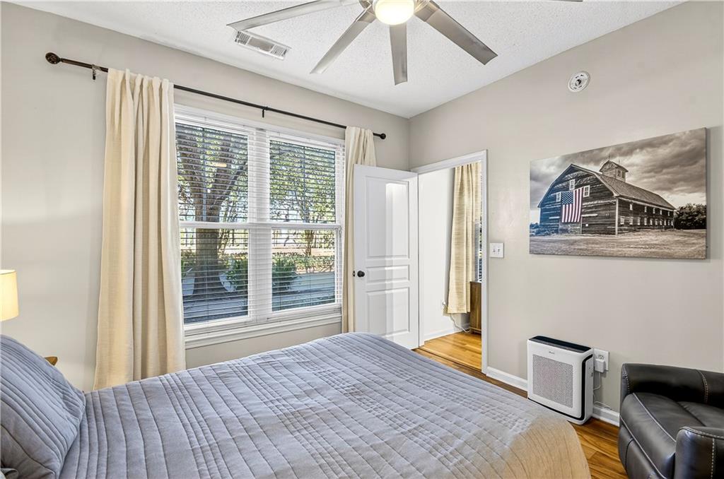10 Perimeter Summit Boulevard, Unit 4113 Brookhaven, GA 30319 - Photo 18 of 53 a bedroom with a bed and glass window