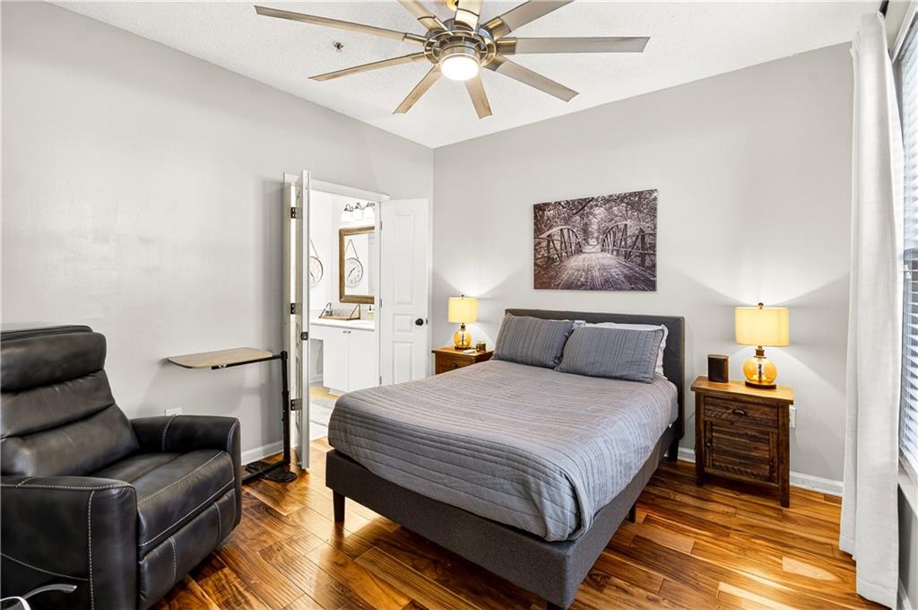 10 Perimeter Summit Boulevard, Unit 4113 Brookhaven, GA 30319 - Photo 20 of 53 a bedroom with a bed and wooden floor