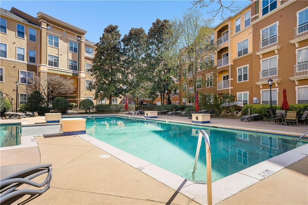 10 Perimeter Summit Boulevard, Unit 4113 Brookhaven, GA 30319 - Photo 25 of 53 a swimming pool with outdoor seating and yard