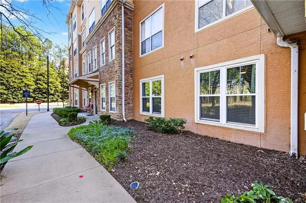 a view of a brick house with a yard