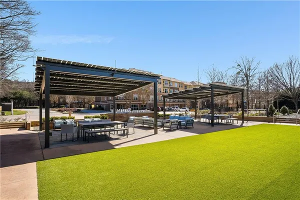 a view of a swimming pool and outdoor seating
