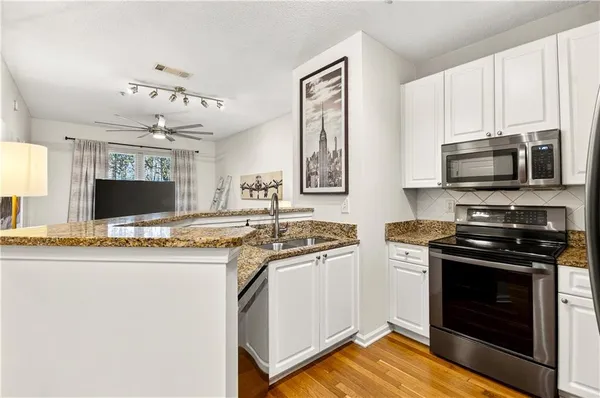 a kitchen with stainless steel appliances a stove microwave and a refrigerator
