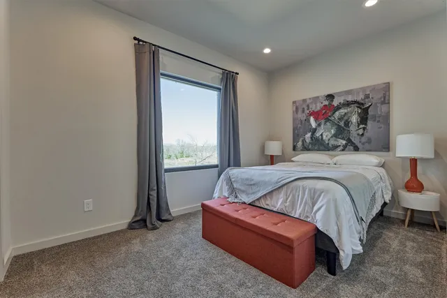 a bedroom with a bed and a painting on the wall