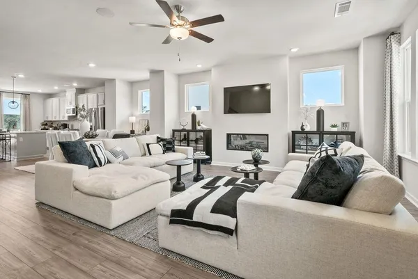 a living room with furniture a fireplace and a flat screen tv