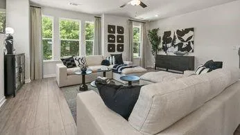 a bedroom with a bed couch and a large window