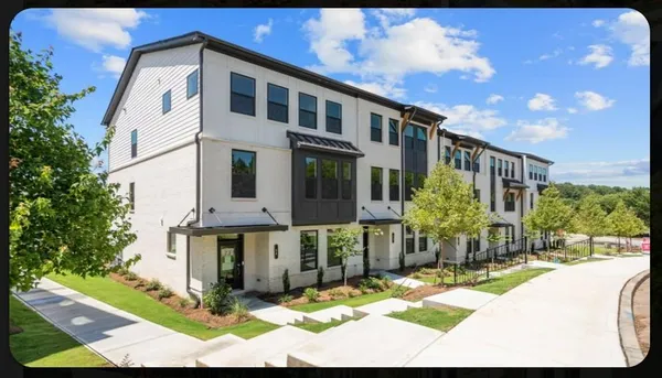 a view of a house with yard and sitting area